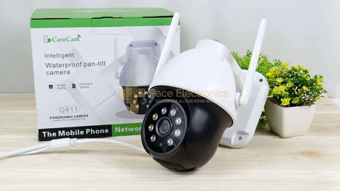 CareCam Intelligent Waterproof Pan-Tilt Camera Q811 displayed on a wooden table with original packaging and a plant in the background.