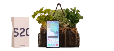 Samsung Galaxy S20FE 5G unlocked smartphone displayed with stylish plant decor and packaging